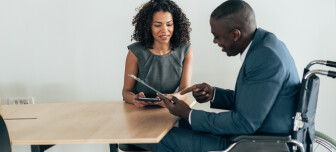 Business people having discussion for new agreement in the office. Africanamerican businessman in wheelchair on job interview