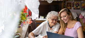 Carer and patient using laptop