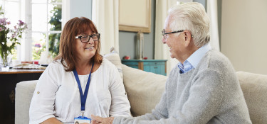 Carer and patient holding hands